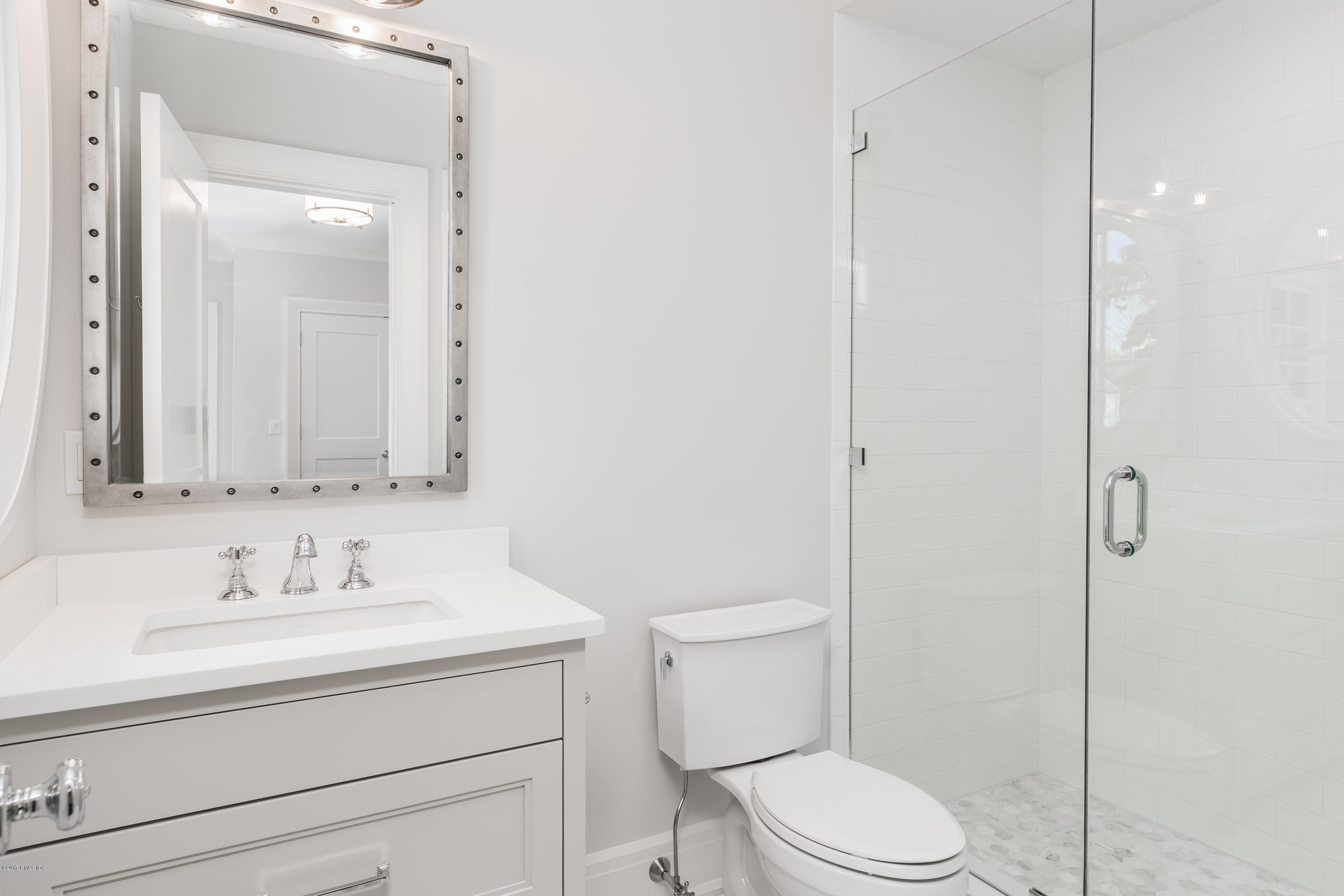 9 Shaw Place Riverside, CT 06878 - Photo 33 of 39 a bathroom with a toilet sink vanity and mirror