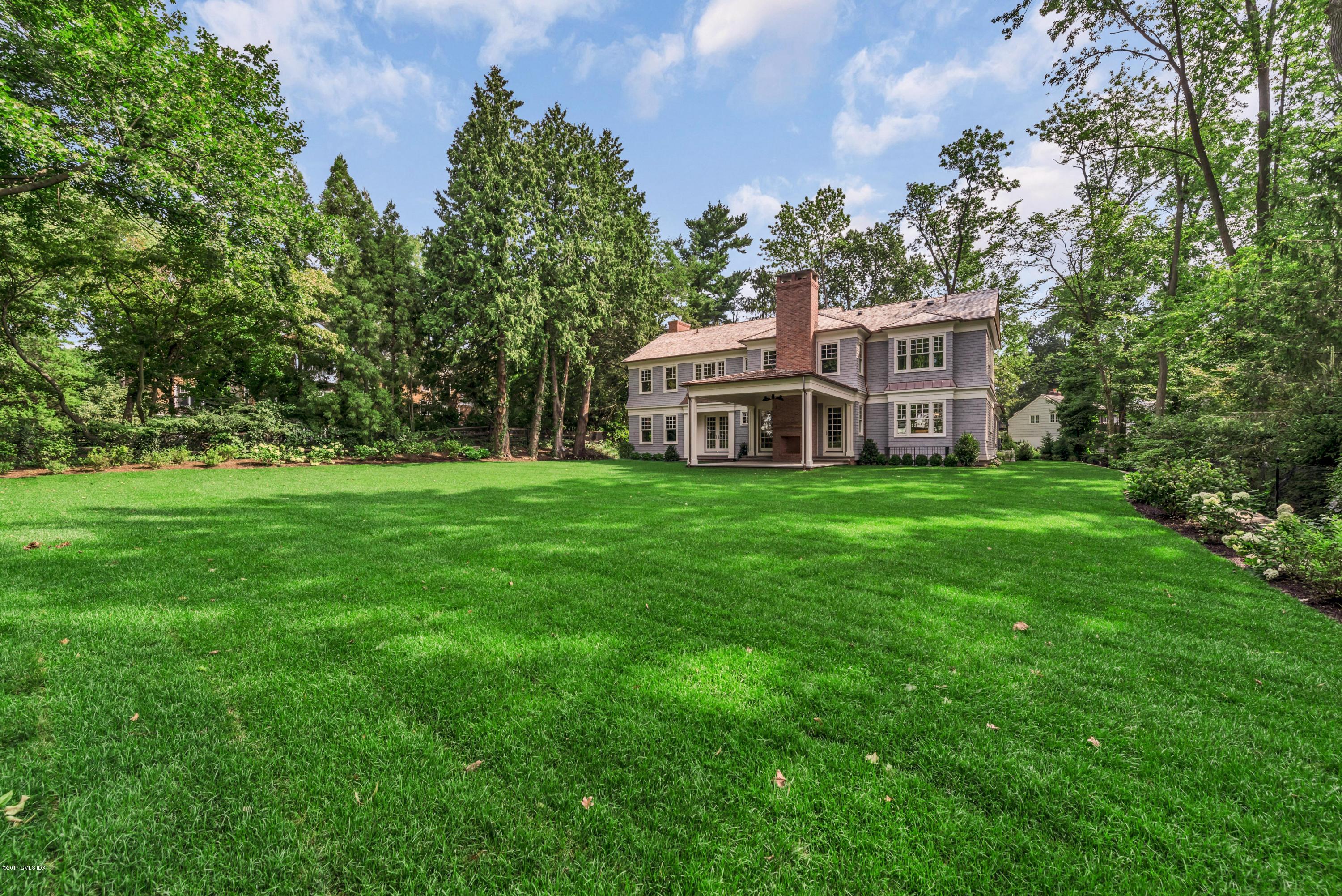 9 Shaw Place Riverside, CT 06878 - Photo 4 of 39 a view of a house with a big yard and large trees