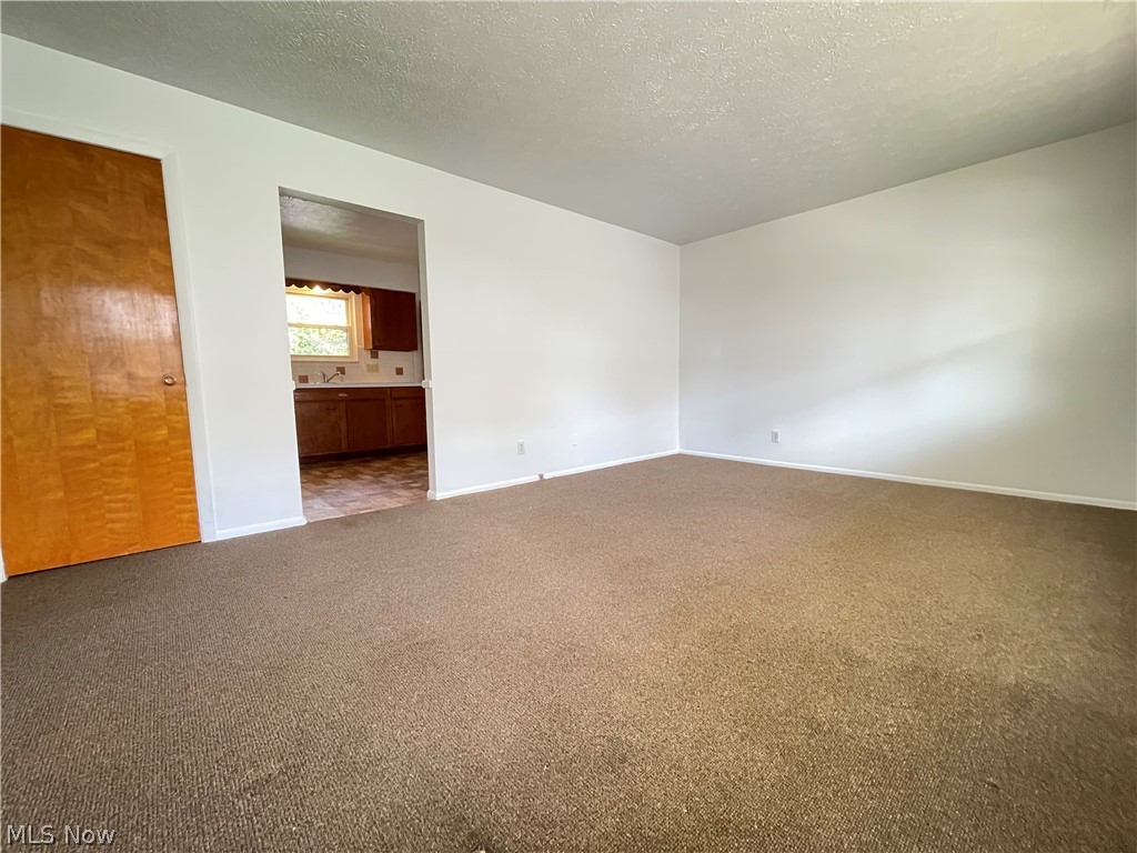 939 Nevin Street Akron, OH 44310 - Photo 18 of 23 Unit B living room
featuring light carpet