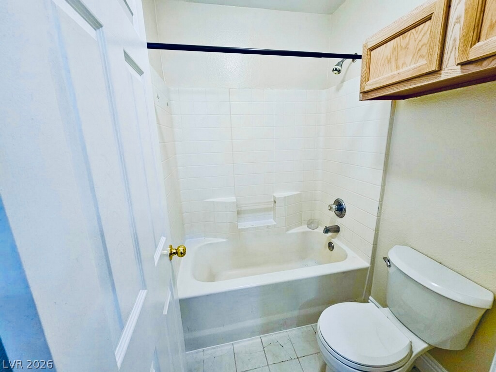 5953 Crumbling Ridge Street Henderson, NV 89011 - Photo 37 of 42 Well-maintained bathroom featuring a full tub, shower, and convenient wall-mounted storage.