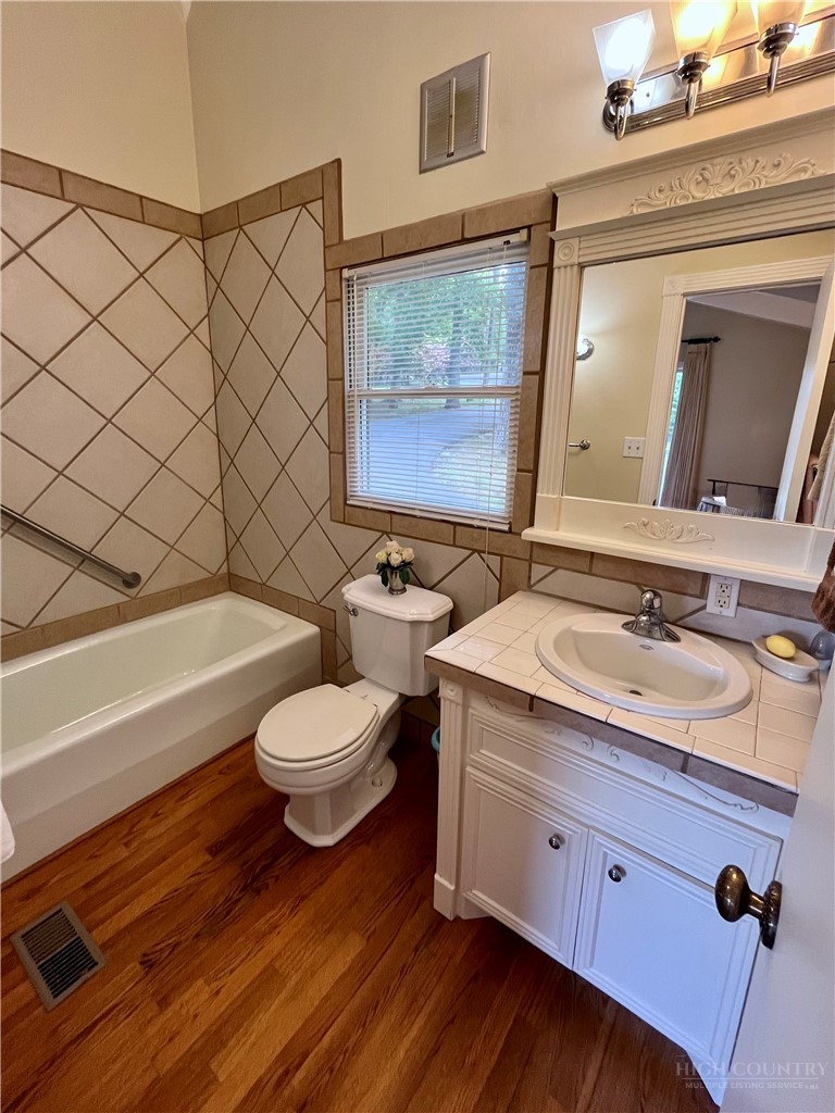638 Ridge Road Glade Valley, NC 28627 - Photo 16 of 44 a bathroom with a double vanity sink mirror and toilet