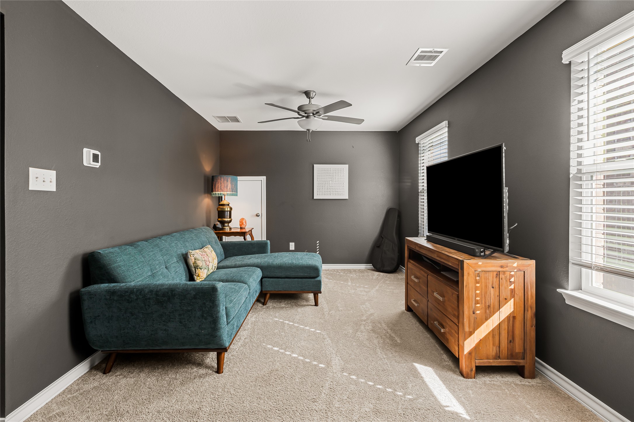862 Pepperbark Loop Buda, TX 78610 - Photo 29 of 40 a living room with furniture and a flat screen tv