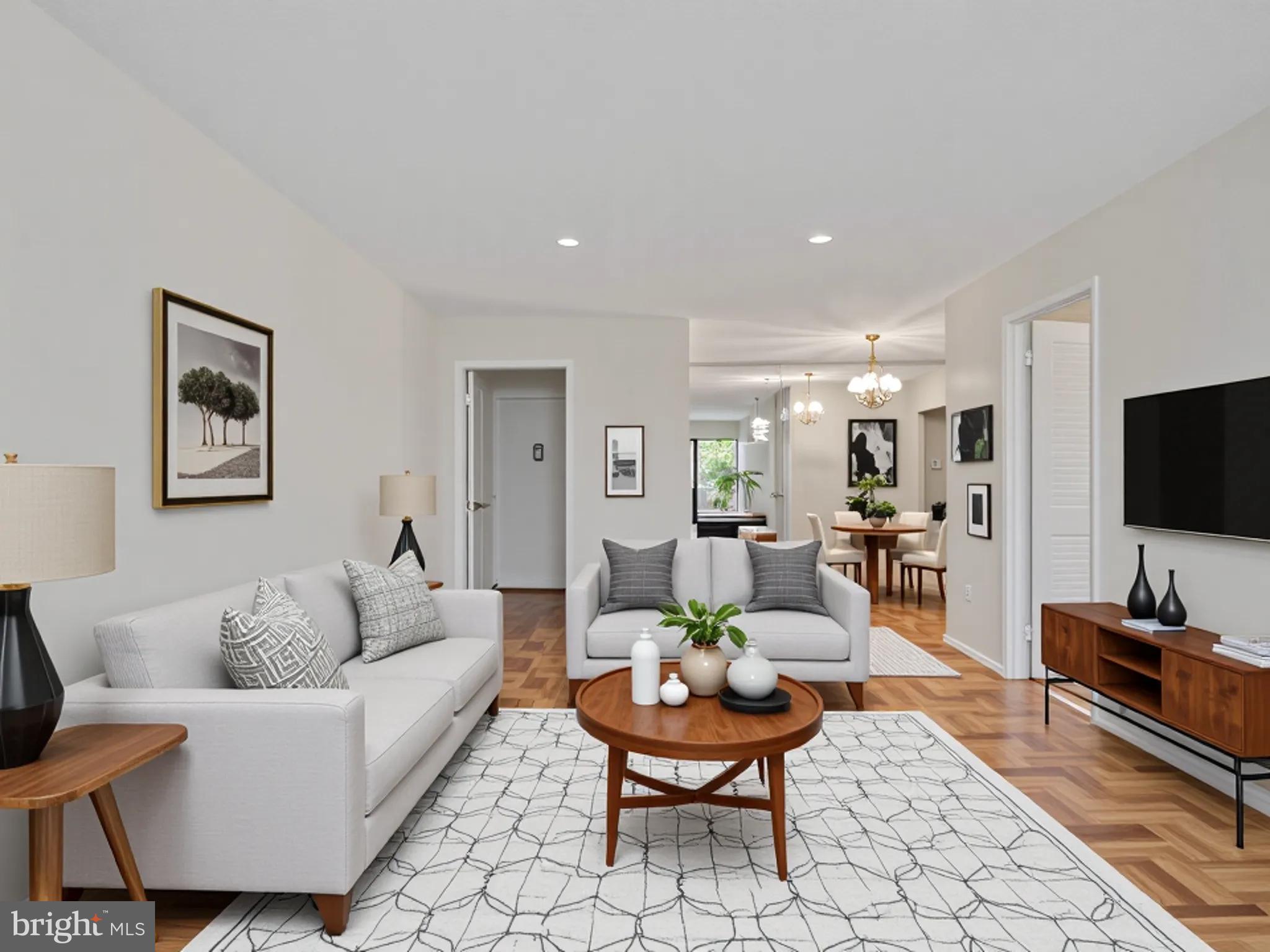 700 7th Street Southwest, Unit 430 Washington, DC 20024 - Photo 2 of 15 a living room with furniture and a flat screen tv