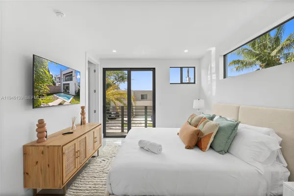 a bedroom with two beds and painting on the wall