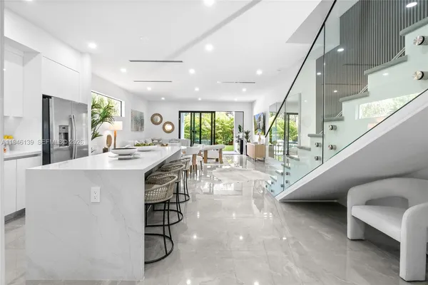 a kitchen with lots of counter top space and dining table