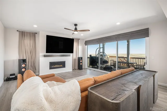 a view of a livingroom with furniture a fireplace and a flat screen tv