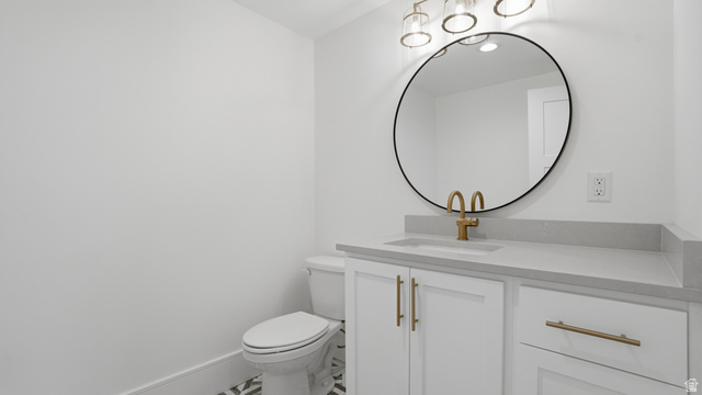 1682 North 1950 W Street, Unit 9 Provo, UT 84604 - Photo 42 of 84 Vanity featuring a built-in sink, light gray countertop, and white cabinetry with gold-finish hardware