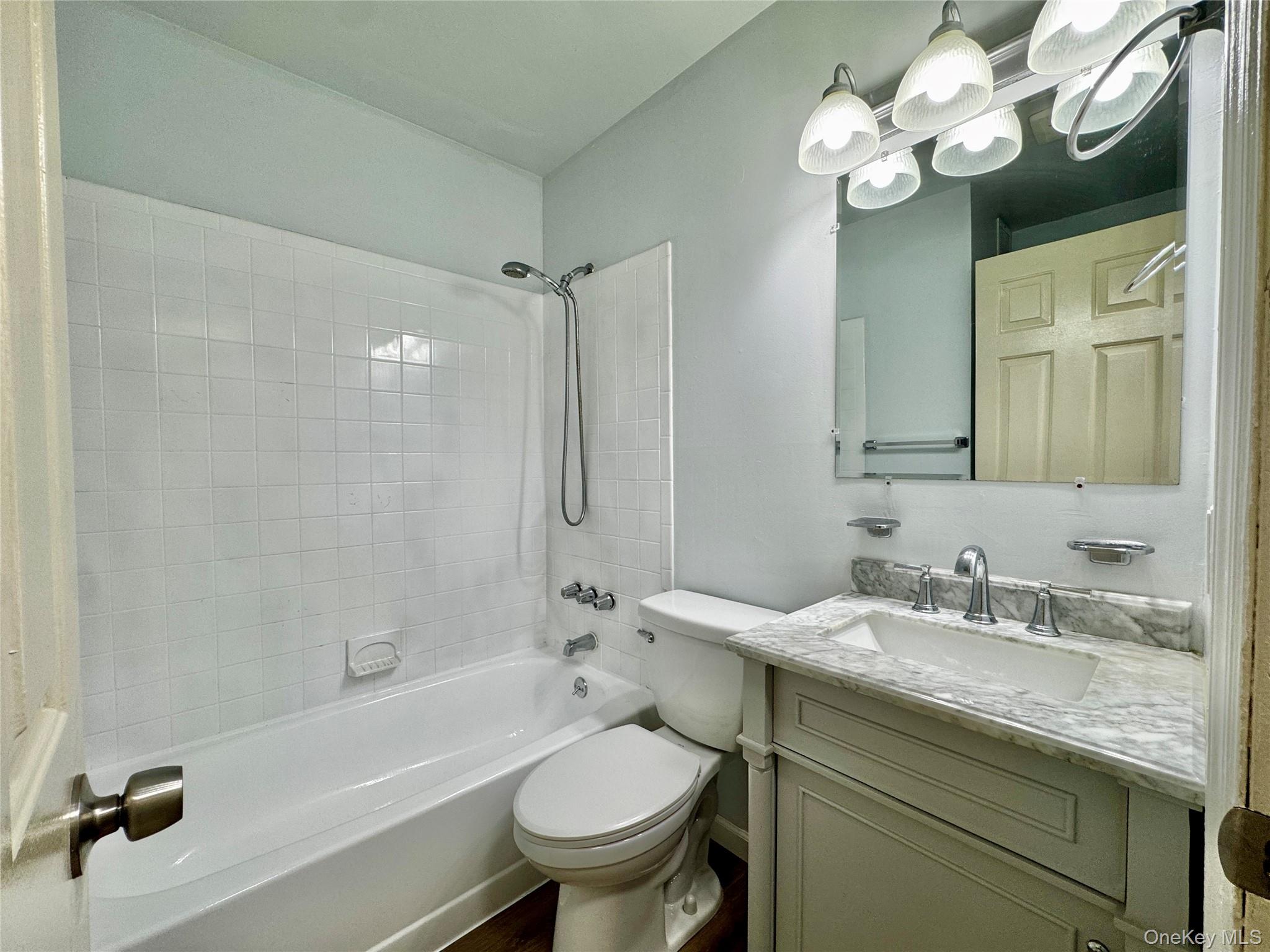 5 Lexington Hills Road, Unit 7 Harriman, NY 10926 - Photo 11 of 21 a bathroom with a granite countertop sink a toilet and bathtub