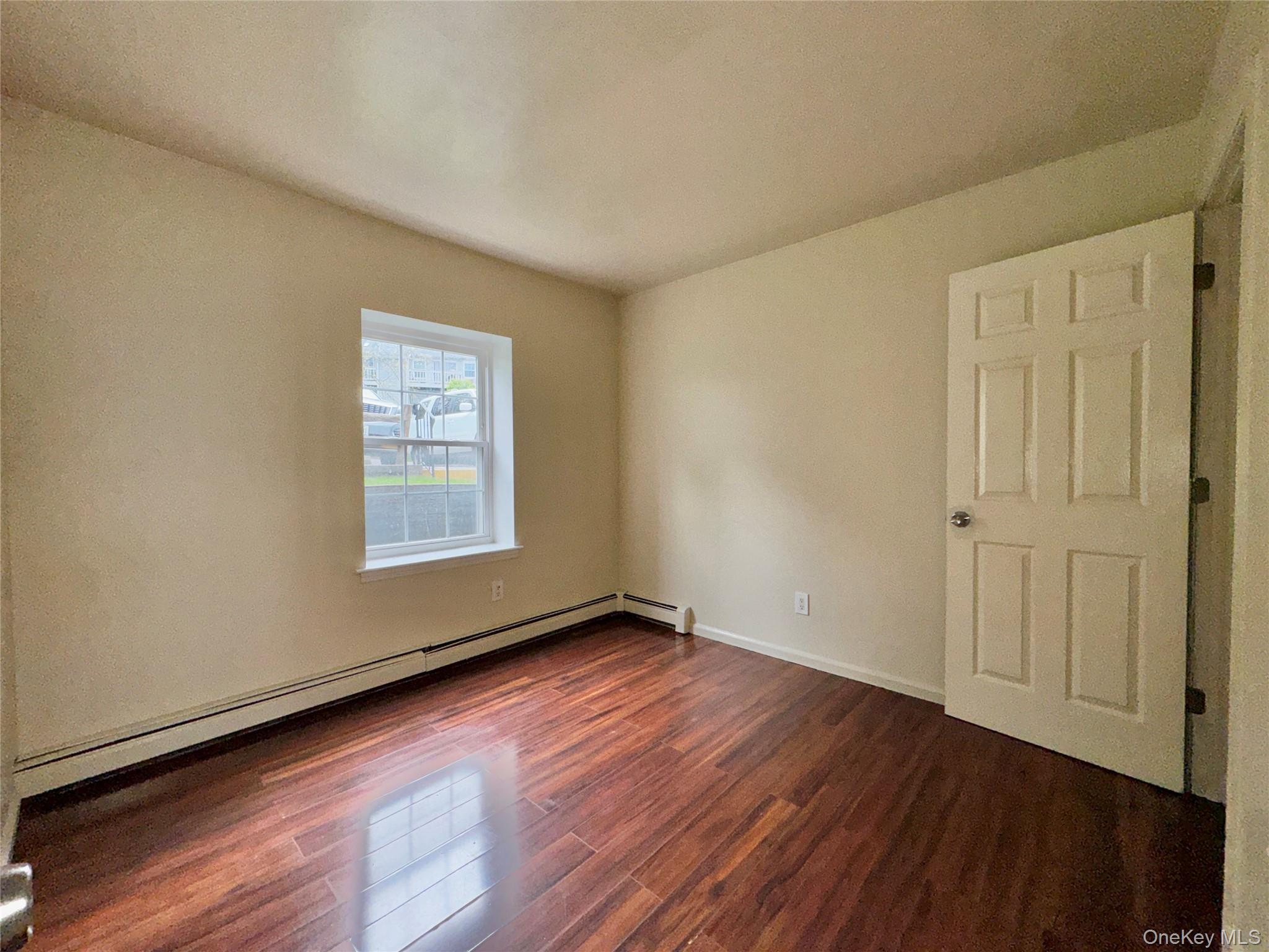 5 Lexington Hills Road, Unit 7 Harriman, NY 10926 - Photo 19 of 21 an empty room with wooden floor and windows