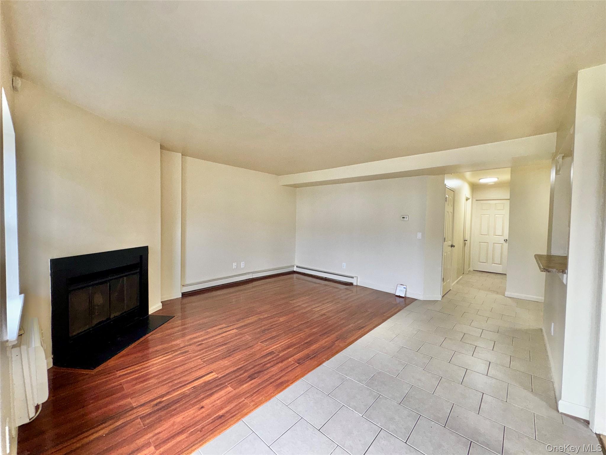 5 Lexington Hills Road, Unit 7 Harriman, NY 10926 - Photo 2 of 21 a view of empty room with wooden floor and fireplace