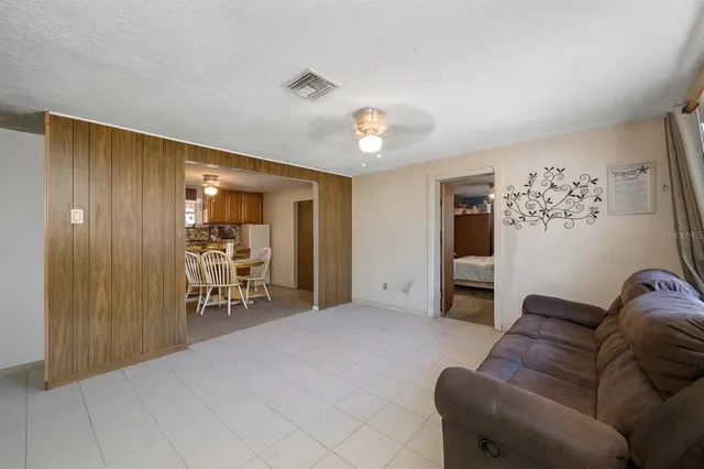 a living room with furniture and a chair