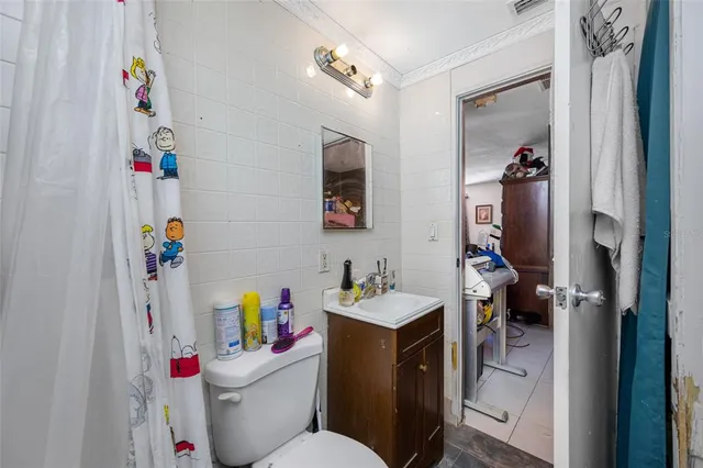 a bathroom with a sink toilet vanity and tub
