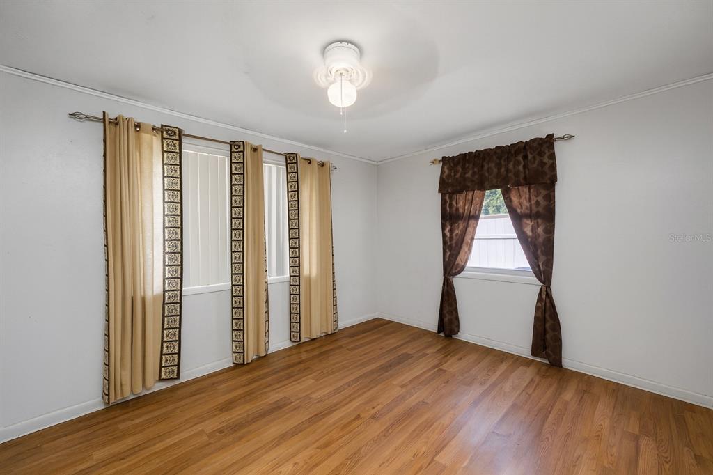 1324 Milton Street Clearwater, FL 33756 - Photo 20 of 47 a view of empty room with wooden floor and fan