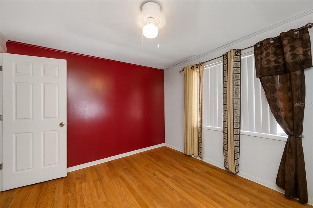 1324 Milton Street Clearwater, FL 33756 - Photo 21 of 47 a view of empty room with wooden floor and fan
