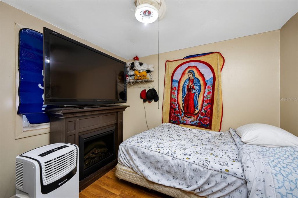 1324 Milton Street Clearwater, FL 33756 - Photo 22 of 47 a bedroom with a bed and a flat screen tv