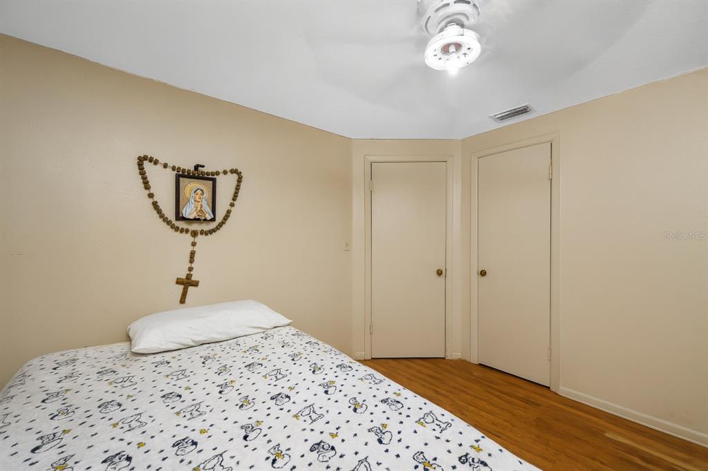 1324 Milton Street Clearwater, FL 33756 - Photo 23 of 47 a bedroom with a bed and a chandelier