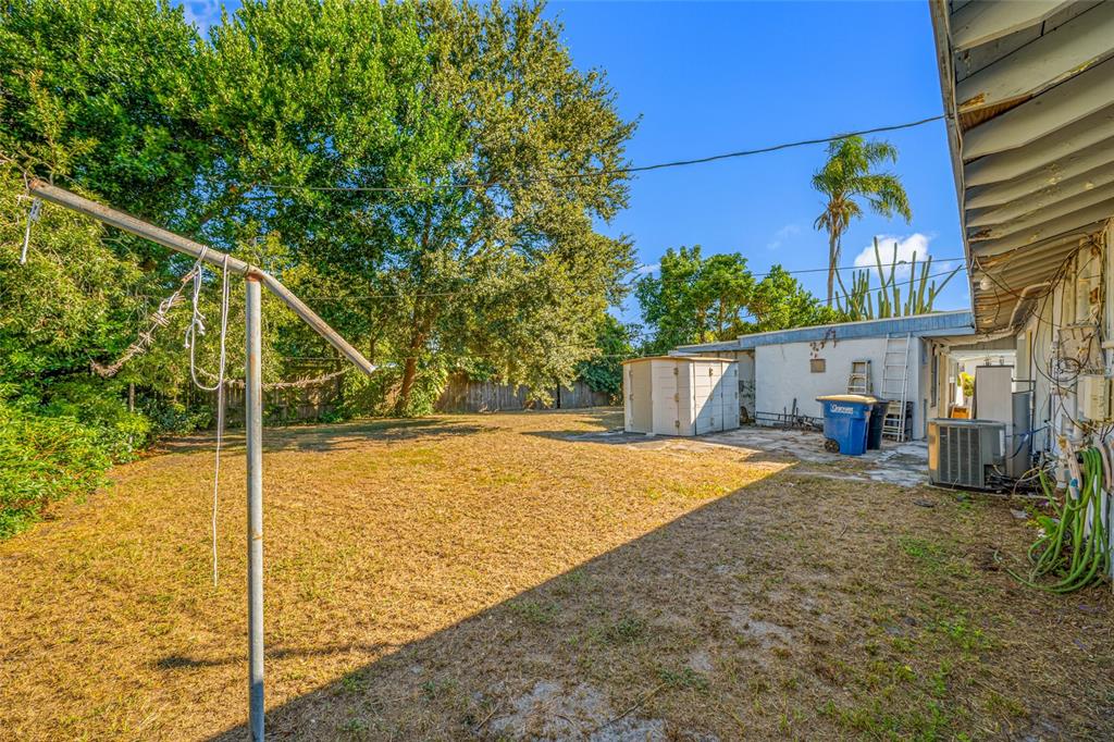 1324 Milton Street Clearwater, FL 33756 - Photo 37 of 47 a view of a house with floor to ceiling window and potted plants