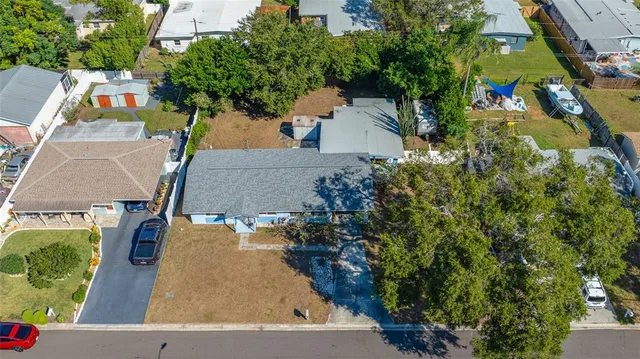 an aerial view of a house with garden space and street view