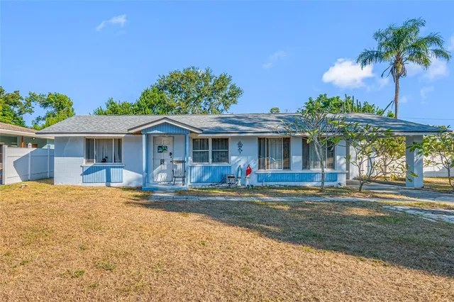 a view of house with outdoor space and swimming pool