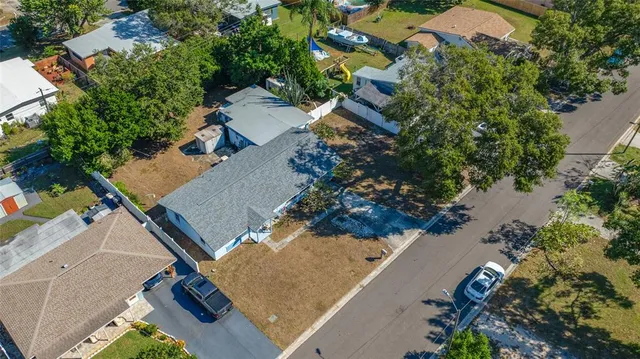 an aerial view of a house with a yard and lake view