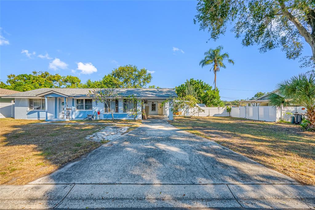 1324 Milton Street Clearwater, FL 33756 - Photo 6 of 47 a front view of a house with a yard and potted plants