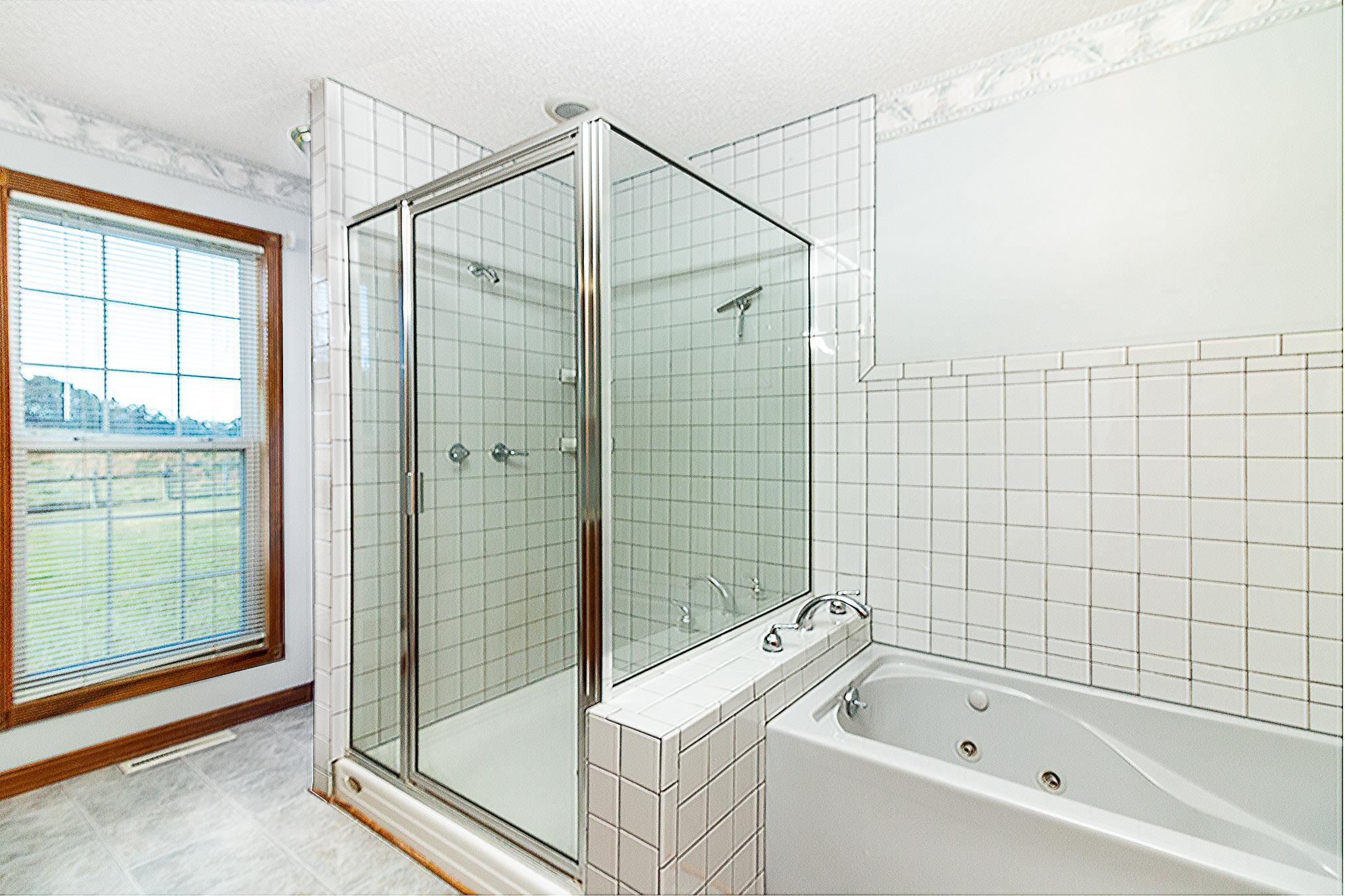 1555 Poplar Hill Road Prospect, TN 38477 - Photo 15 of 29 a bathroom with a bathtub and shower