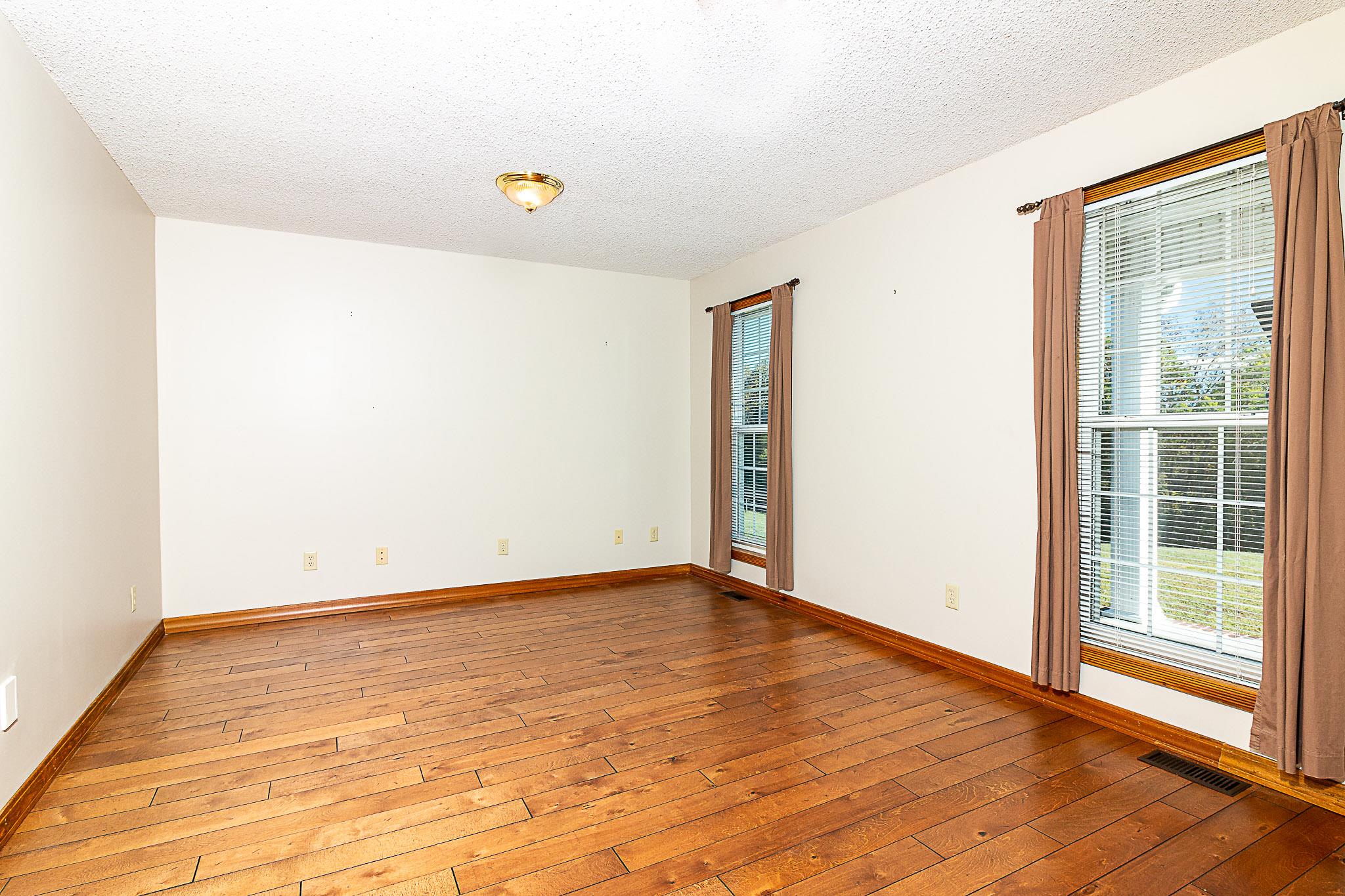 1555 Poplar Hill Road Prospect, TN 38477 - Photo 4 of 29 a view of an empty room with wooden floor and a window