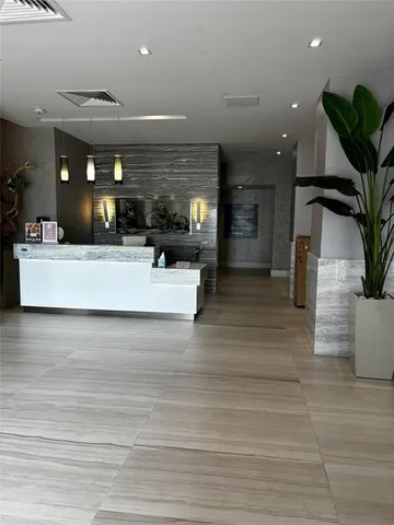 a view of living room kitchen with furniture and a potted plant