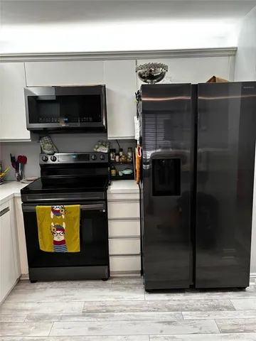 a kitchen with a stove and a microwave