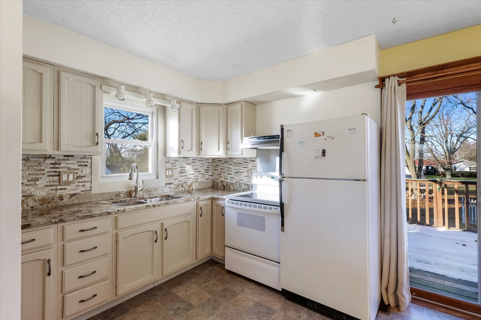 104 Grant Street Philo, IL 61864 - Photo 12 of 44 a kitchen with a white cabinets and white appliances