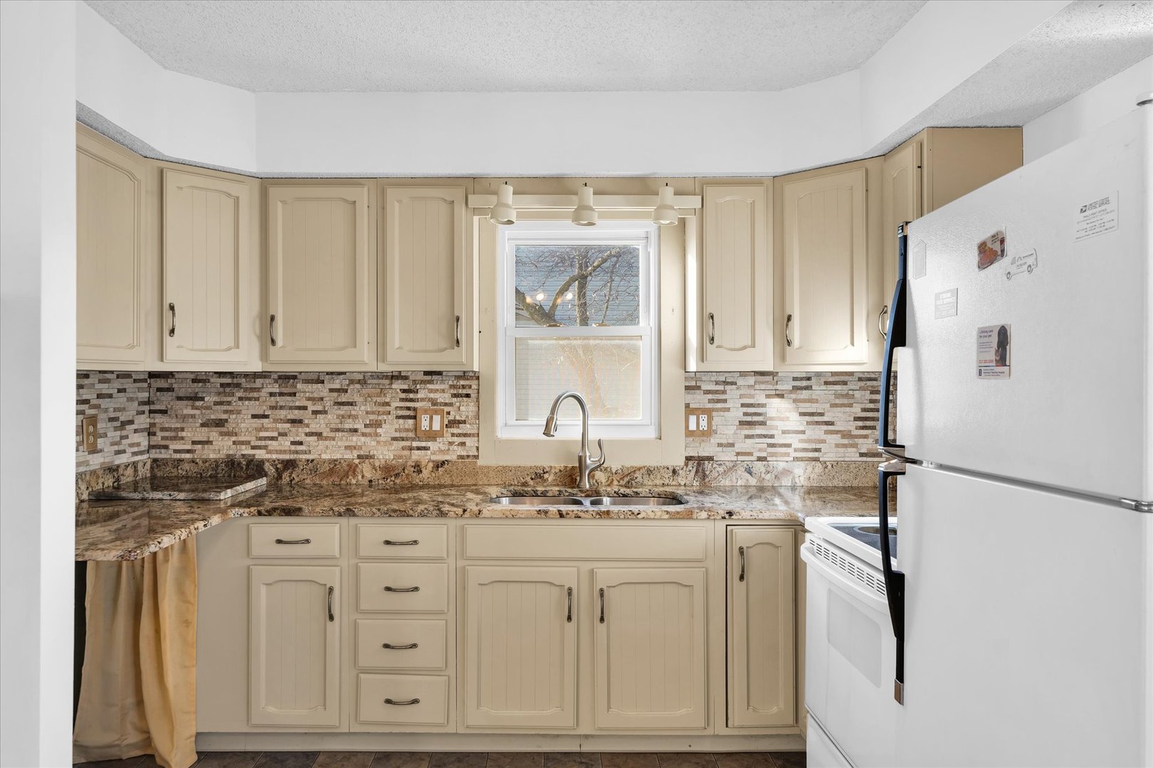 104 Grant Street Philo, IL 61864 - Photo 13 of 44 a kitchen with stainless steel appliances white cabinets and a refrigerator