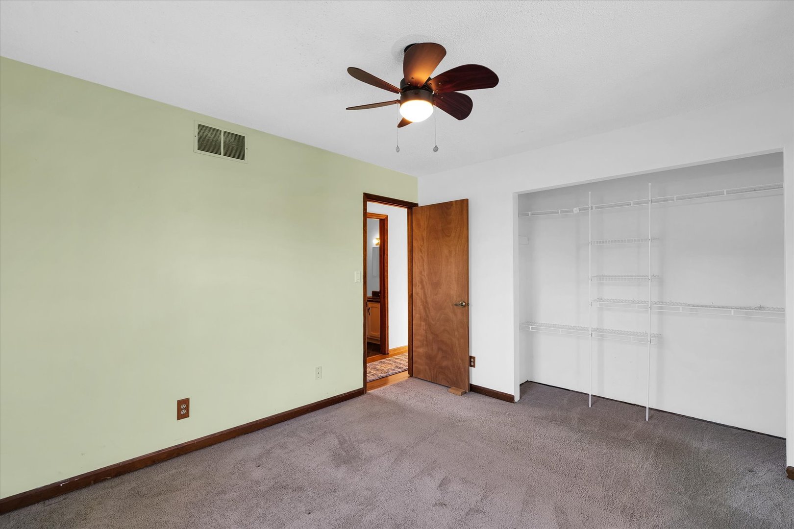 104 Grant Street Philo, IL 61864 - Photo 21 of 44 an empty room with closet and ceiling fan