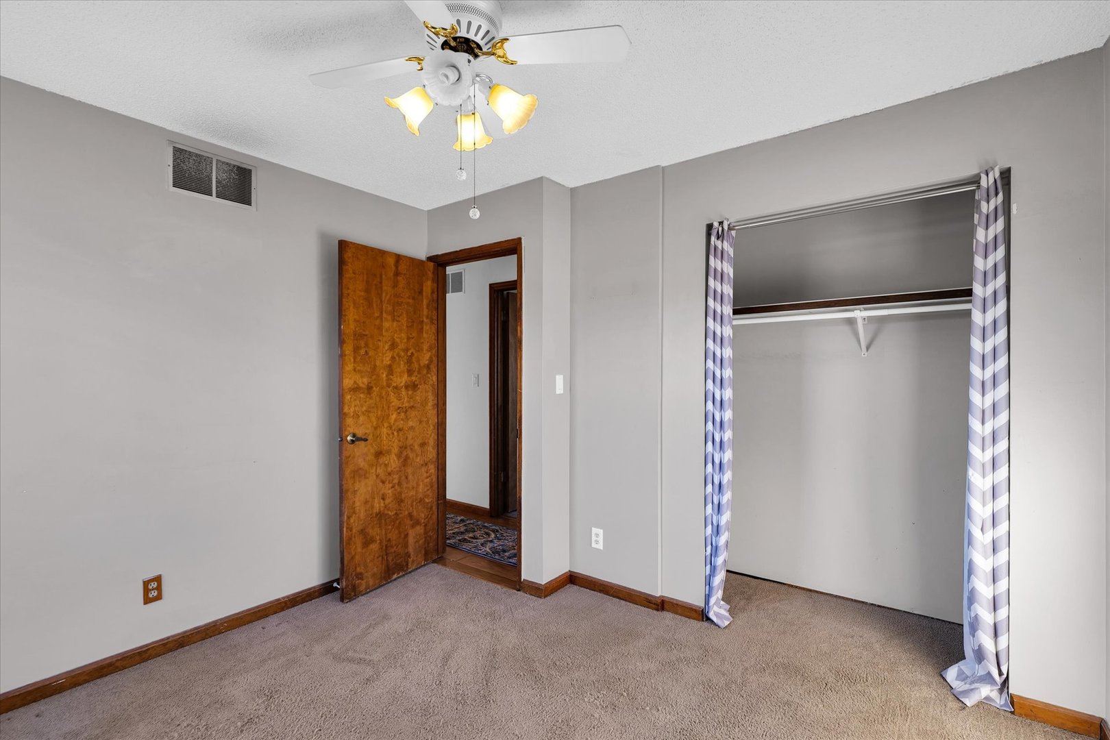 104 Grant Street Philo, IL 61864 - Photo 23 of 44 an empty room with closet and a chandelier fan