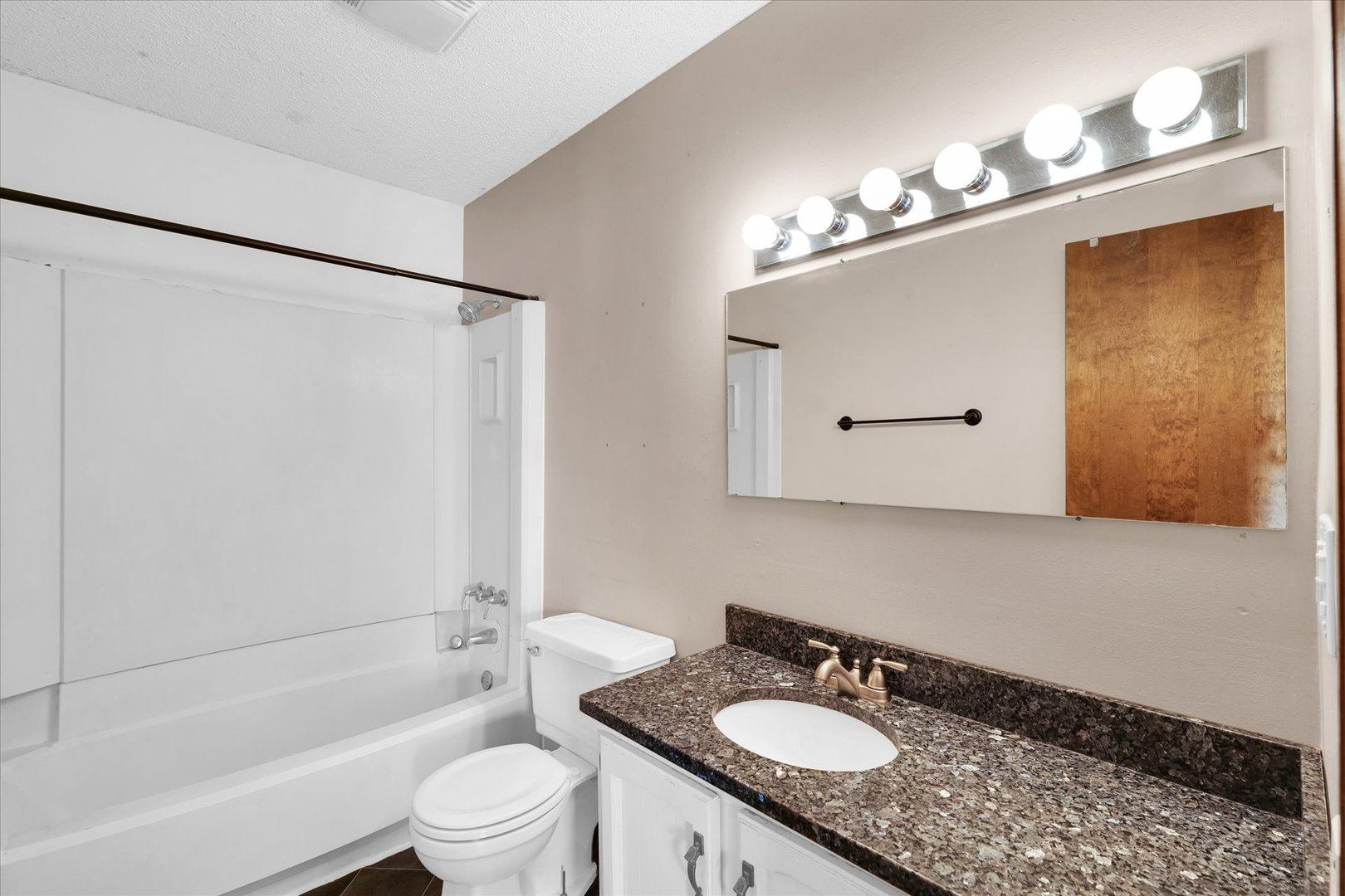 104 Grant Street Philo, IL 61864 - Photo 24 of 44 a bathroom with a granite countertop sink toilet and shower