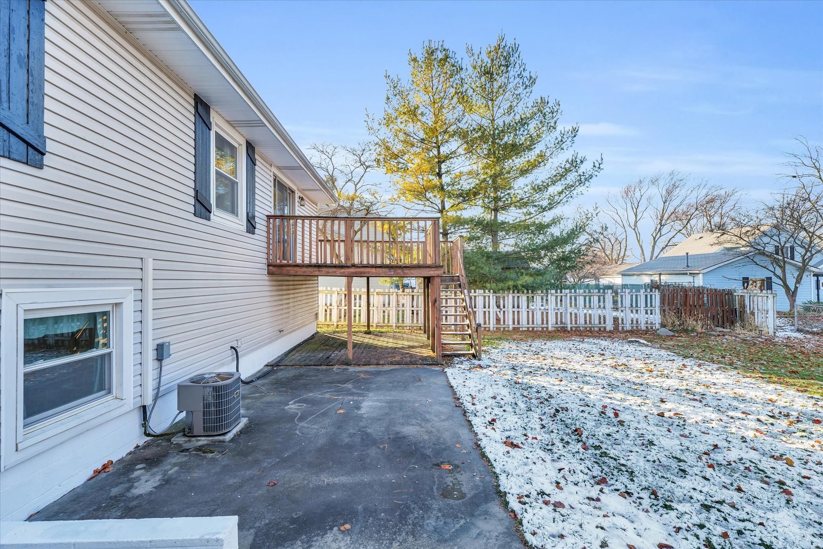 104 Grant Street Philo, IL 61864 - Photo 38 of 44 a view of a backyard with large trees and wooden fence