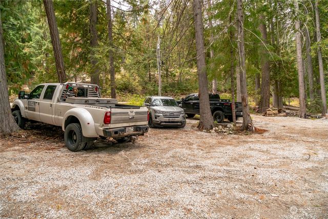 a view of a backyard with table and chairs a barbeque and a stove