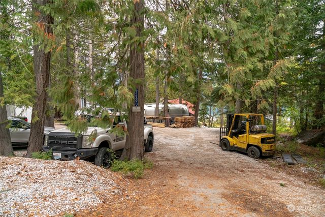 a view of swimming pool with chairs and plants