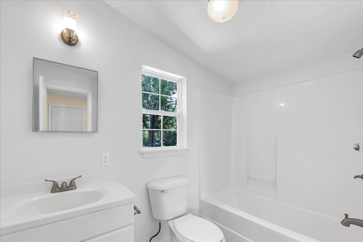 104 Locust Street Liberty, TN 37095 - Photo 23 of 57 a bathroom with a toilet sink vanity tub and shower