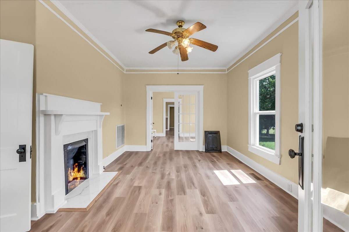 104 Locust Street Liberty, TN 37095 - Photo 4 of 57 a view of empty room with wooden floor and fireplace