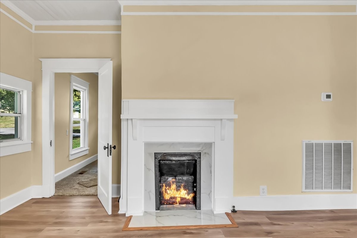 104 Locust Street Liberty, TN 37095 - Photo 6 of 57 a living room with a fireplace and a wooden floor