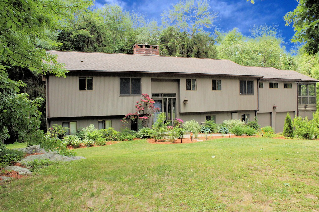 33 Sunset Road Carlisle, MA 01741 - Photo 1 of 27 a view of a house with a garden and plants