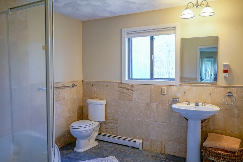33 Sunset Road Carlisle, MA 01741 - Photo 11 of 27 a bathroom with a toilet sink and mirror