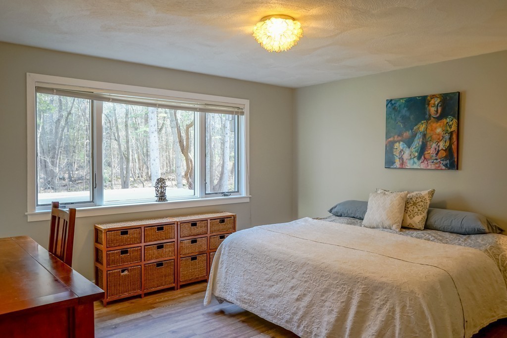 33 Sunset Road Carlisle, MA 01741 - Photo 15 of 27 a bedroom with a bed and a large window