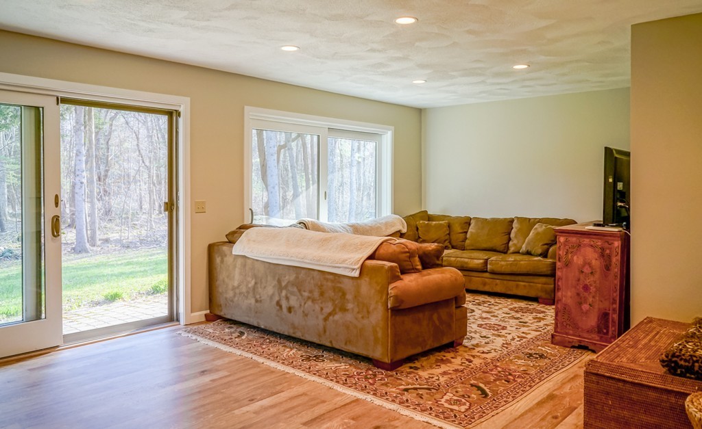 33 Sunset Road Carlisle, MA 01741 - Photo 19 of 27 a living room with a couch and wooden floor