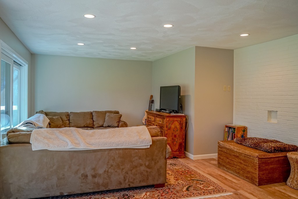 33 Sunset Road Carlisle, MA 01741 - Photo 20 of 27 a living room with furniture and a flat screen tv