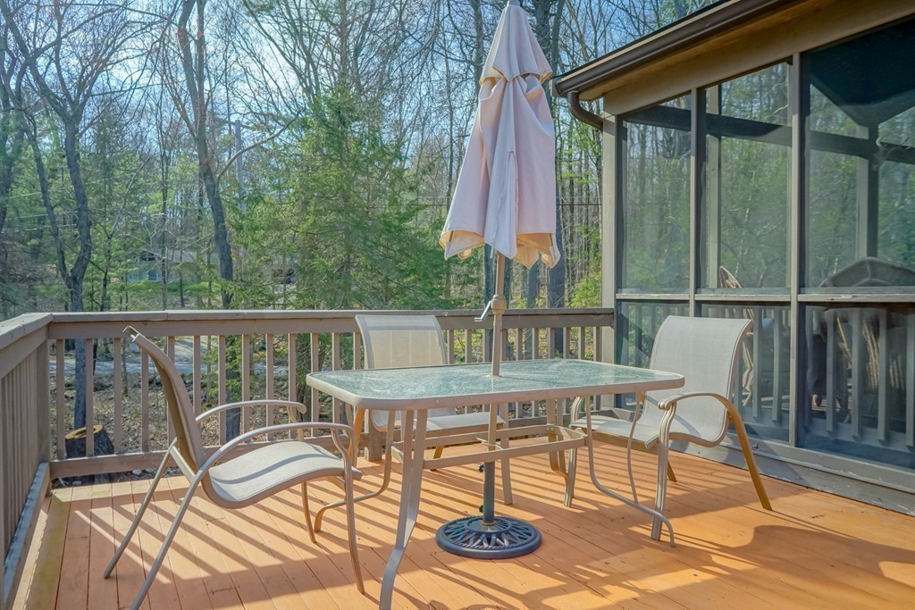 33 Sunset Road Carlisle, MA 01741 - Photo 24 of 27 a balcony of a house with wooden floor outdoor seating and yard in the back