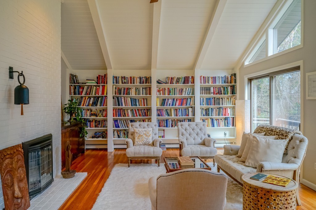 33 Sunset Road Carlisle, MA 01741 - Photo 3 of 27 a living room with furniture a rug and a book shelf