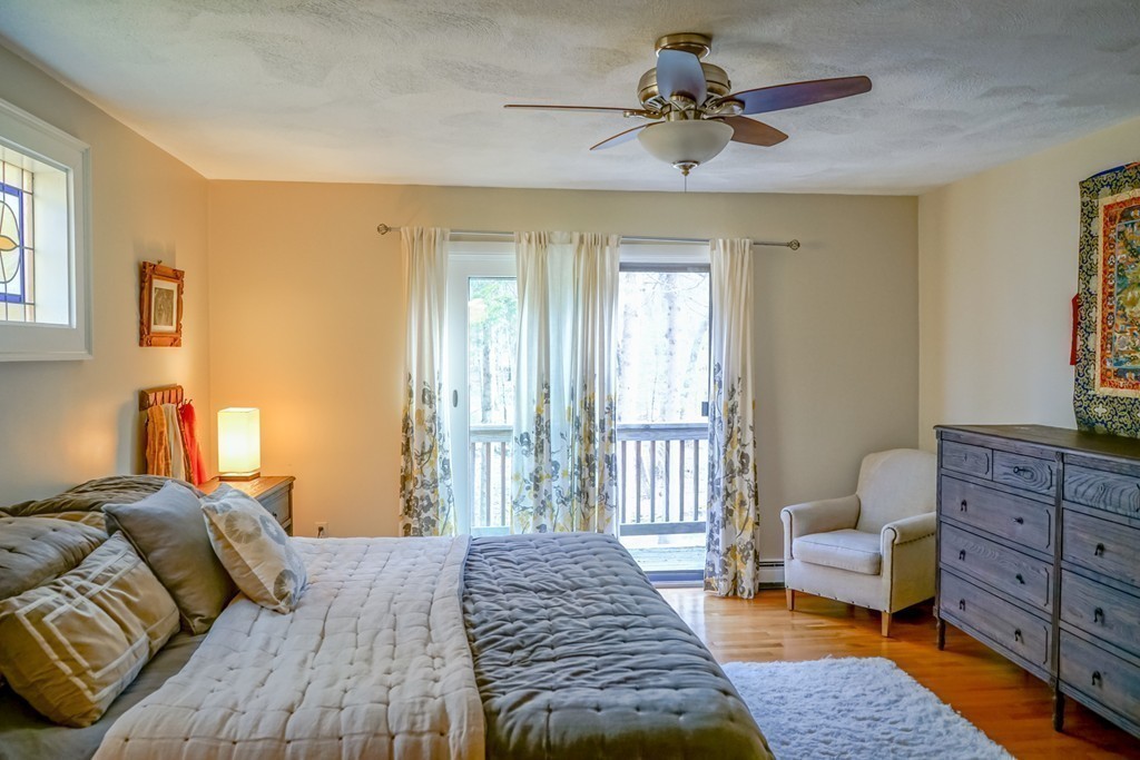 33 Sunset Road Carlisle, MA 01741 - Photo 10 of 27 a bedroom with a bed and a chandelier