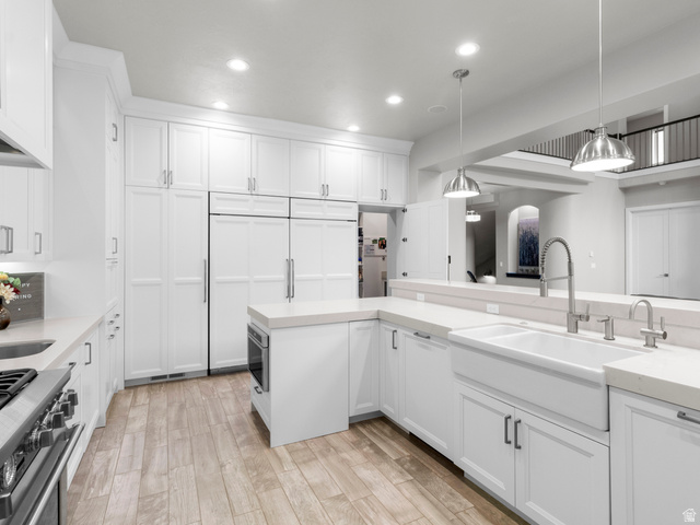 614 East High Lane Alpine, UT 84004 - Photo 34 of 75 Kitchen with white cabinetry, stainless steel range, hanging light fixtures, and light wood-type flooring