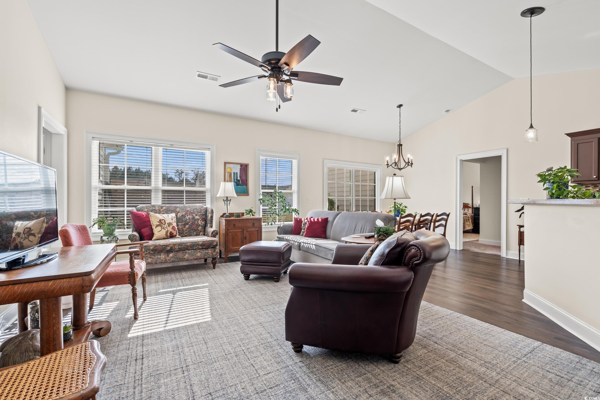 153 Grier Crossing Road Conway, SC 29526 - Photo 3 of 26 Living room with dark wood-style flooring, ceiling fan, a chandelier, and high vaulted ceiling